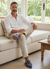 Load image into Gallery viewer, THE_NOUR_handcrafted_Moroccan_leather_sole_slipper_in_blue_embriodery_on_seated_male_model_luxulcollective