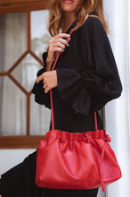 Load image into Gallery viewer, THE TALI handcrafted leather crossbody clutch in Vintage Red, on model— LUXUL COLLECTIVE